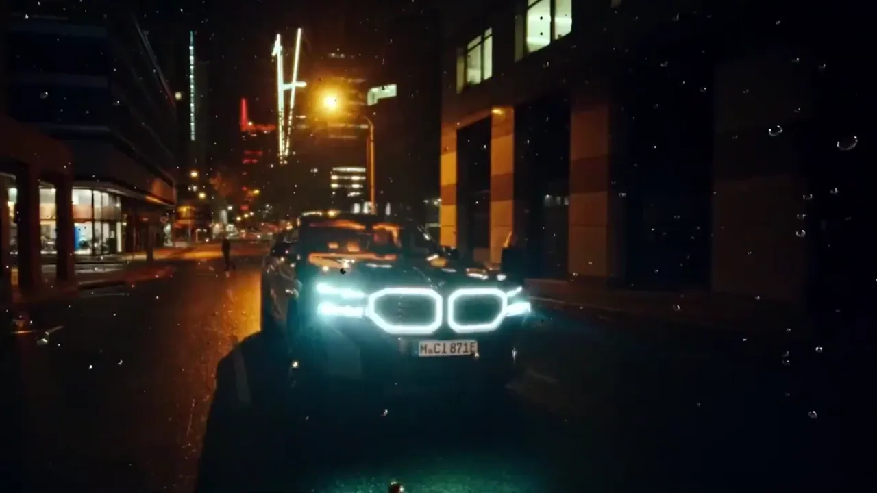 A car's headlights on a wet Cape Town street at night