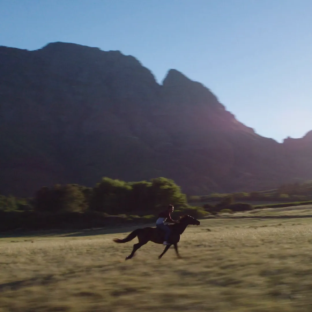 A rider on a mountain road, filmed from the air