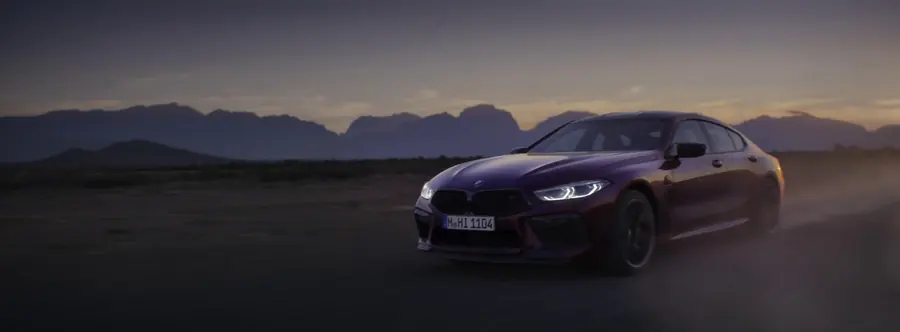 M8 parked at first light with mountains behind