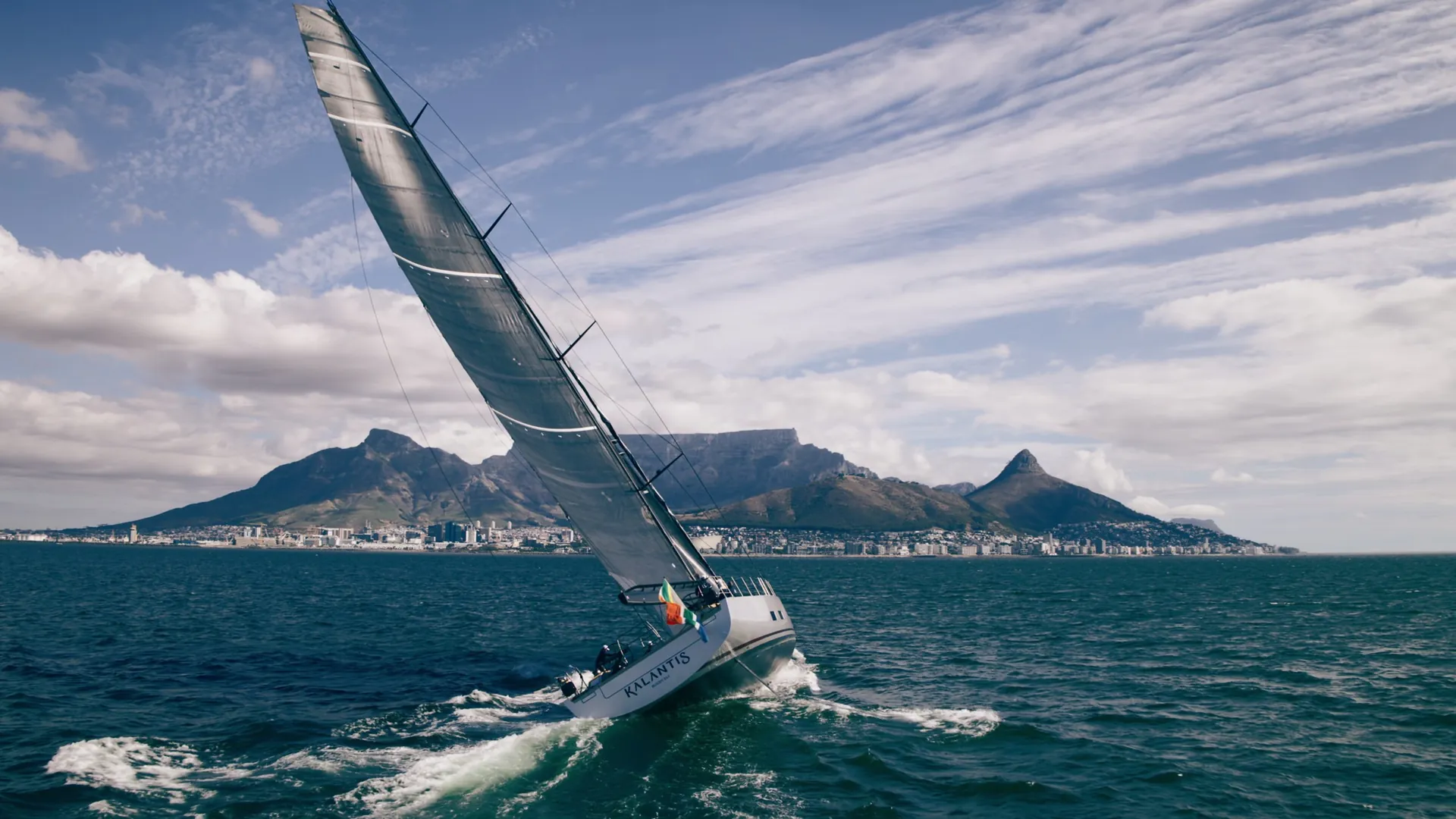 Kalantis under full sail off Cape Town, filmed from the air, from the water line and on deck.
